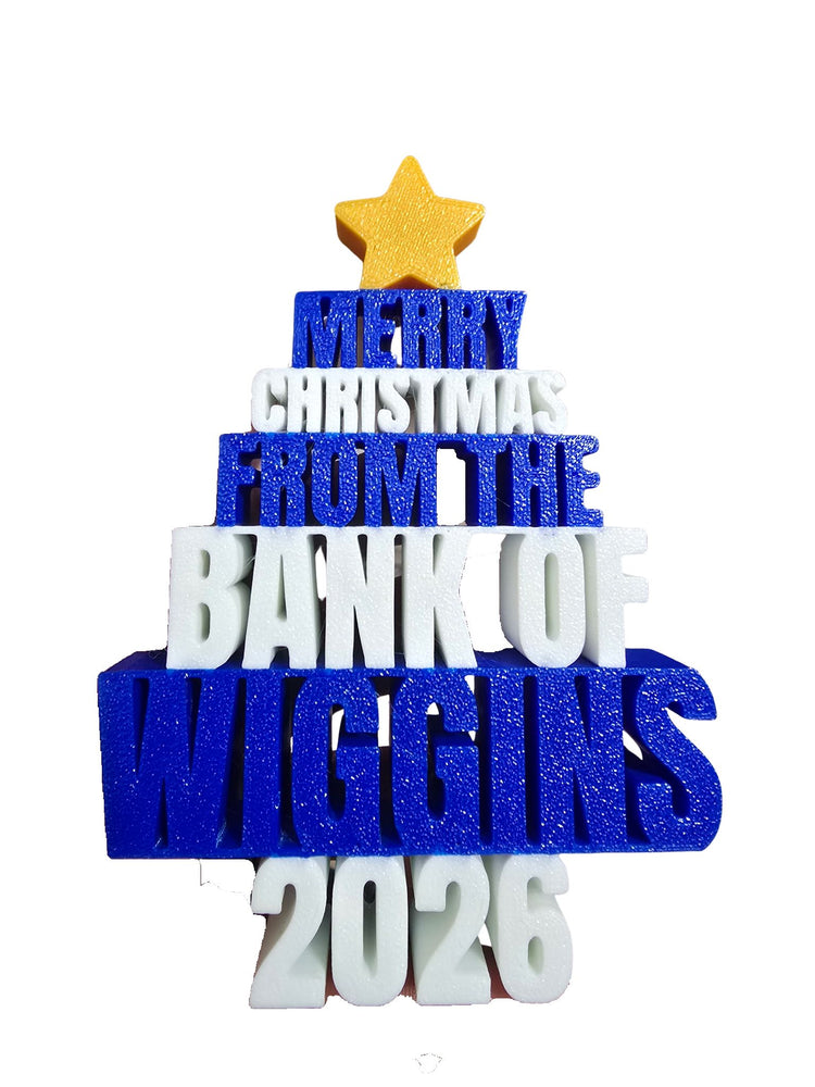 Tree-shaped Bank of Wiggins 2026 Christmas ornament with blue and white lettering and a yellow star.